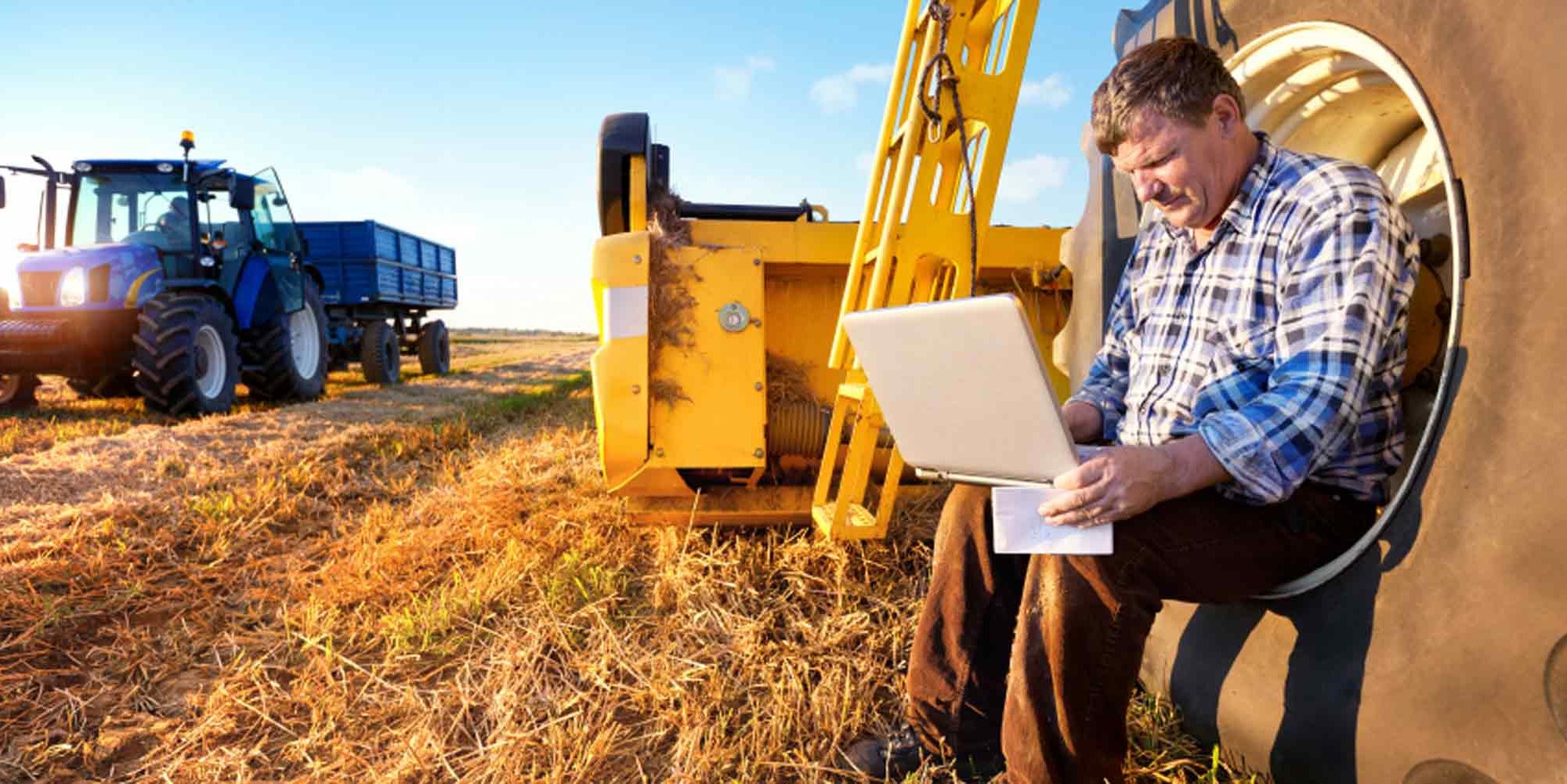 Heart of Iowa Mutual Insurance Association - Farmer Checking Laptop While in the Field